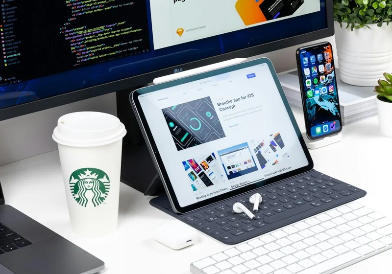A tablet and phone on a tidy desk displaying a clean, modern website.